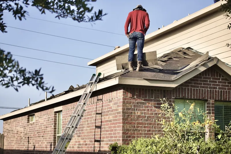Professional roofer working on a residential roof in Renassance